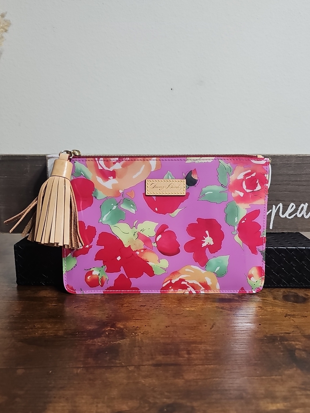 Dooney And Bourke Vinyl And Leather Floral Zip Clutch with Tassel